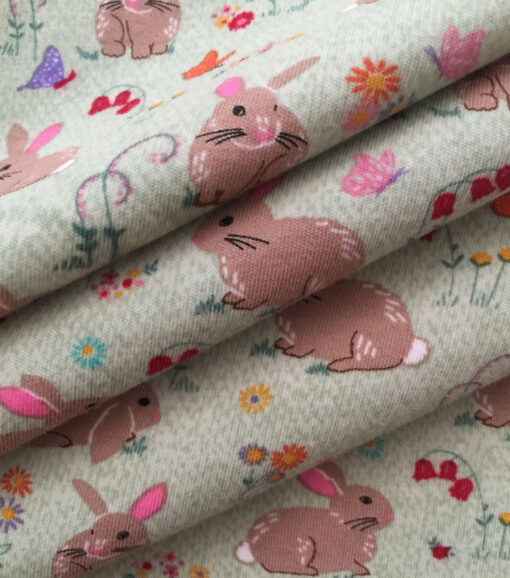 Bunnies on Green Interlock Knit Fabric - Image 3
